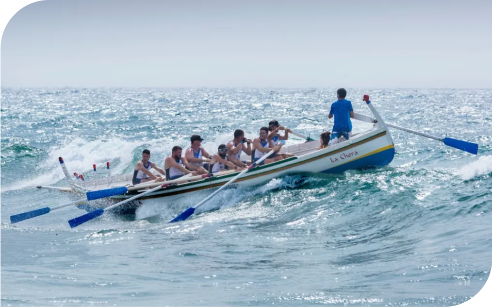 a group of people rowing a boat